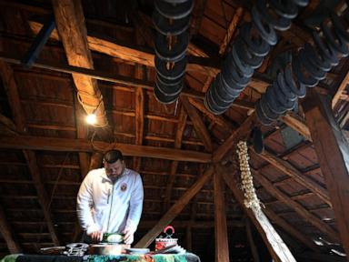 A traditional sausage in the shape of a horseshoe is ‘ironed’ for dryness in southeastern Serbia